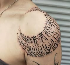 a woman's shoulder with tattoos on it and writing all over the chest area