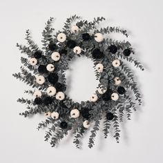 a wreath made out of black and white flowers