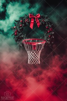 a wreath hanging from the side of a basketball hoop with a red bow on it