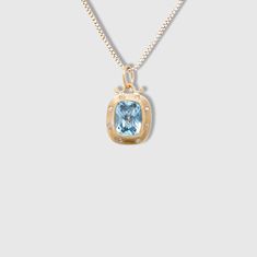 3.65ct Faceted Checkerboard Light Blue Topaz Charm Pendant Necklace with Diamonds, 24kt Gold and Silver by Prehistoric Works of Istanbul, Turkey. Light Blue Topaz - 3.65cts, Diamonds - 0.08cts. This stunning topaz is framed in 24kt gold with 8 diamonds. Looks beautiful alone or paired with other charms.  Sure to make a subtle, striking statement.  Measures 12.5mm x 17mm. 24kt Gold - 1.57 g Sterling Silver - 0.87 g Diamonds - 0.08 ct Blue Topaz - 3.65 ct Luxury Gold Necklaces With Accent Stones, Formal Yellow Gold Necklace With Accent Stones, Yellow Gold Necklace With Accent Stones For Gift, Gold Blue Topaz Necklace For Anniversary, Yellow Gold Jewelry With Diamond Accents And Blue Topaz, Gold Necklaces With Accent Stones For Formal Occasions, Elegant Gold Necklaces With Accent Stones, Elegant Gold Necklace With Accent Stones, Gold Oval Necklaces With Accent Stones