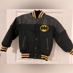 Brand New! Custom Made Jacket, Would Fit A Child Appx 4 Years Old To Probably 8 Years Old. Black And Yellow Varsity Letterman Jacket With Batman On The Back, Dark Charcoal Colored Sleeves Hooded Winter Outerwear With Character Print, Winter Hooded Outerwear With Character Print, Hooded Character Print Fall Outerwear, Pop Culture Long Sleeve Outerwear For Streetwear, Winter Cartoon Print Outerwear For Streetwear, Streetwear Long Sleeve Outerwear With Character Print, Streetwear Outerwear With Character Print, Long-sleeve Character Print Streetwear Outerwear, Cotton Outerwear With Character Print And Long Sleeves