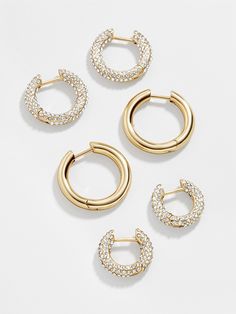 Three times the earrings, three times the layering. The Lucy Earring Set is complete with three pairs of huggie hoop earrings. Two pairs are encrusted with crystals, while the third is crafted in graphic gold. Wear a few together or break them apart for easy stacking every single day. Preppy Jewelry, Gold Girl, Ups Shipping, 18k Gold Earrings, Crystal Hoop Earrings, Jewelry Accessories Ideas, Dope Jewelry, Jewelry Lookbook, Earrings In Gold