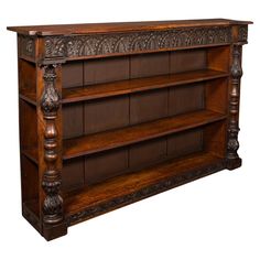 an old wooden book shelf with carvings on it