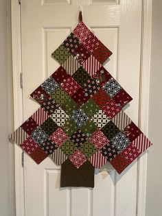 a quilted christmas tree hanging on the front door