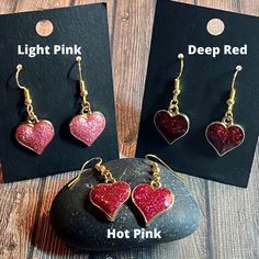 Show yourself or a friend some love with these adorable hypoallergenic sparkly glitter enamel heart earrings! These are great for formal or casual wear and are made of durable, brightly colored glittery enamel and metal alloy. Available in 3 colors: Deep red, hot pink and light pink Dangle length is approximately 1-inch. Heart charm is approximately 0.6-inch by 0.7-inch Hypoallergenic earring hooks Valentine's Day Heart Charm Enamel Earrings, Valentine's Day Silver Glitter Jewelry, Silver Glitter Jewelry For Valentine's Day, Glitter Jewelry Gift, Glitter Jewelry For Gifts, Valentine's Day Gift Enamel Earrings, Sparkling Heart-shaped Earrings For Gift, Sparkling Heart Earrings For Gift, Cute Glitter Jewelry Gift