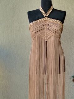 a mannequin wearing a dress with fringes on it