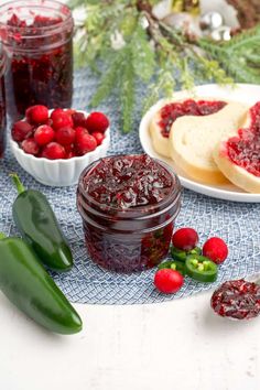 cranberry sauce in a jar surrounded by fresh berries and other foodstuffs