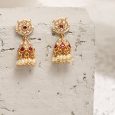 Description This timeless jhumki earring is perfectly crafted with polki stones on a gold-plated setting and finished with precious stones. An elegant wardrobe essential, these jhumki earrings will be your favorite. Style with the complementary accessories from the Vihara family for a grand look. This is the perfect choice for festival events and weddings. Product Information Materials used: 925 Silver with 1.0-microns Antique Gold Plating Stones: Semi precious stones Length: 3.5 cm Findings: Ho Luxury Fusion Style Jhumkas With Stone Work, Jhumkas With Stone Work For Eid Reception, Eid Jhumkas With Stone Work For Reception, Eid Reception Jhumkas With Stone Work, Kundan Jhumkas For Eid Reception, Diwali Temple Jewelry Pearl Earrings With Latkans, Bollywood Style Gold Plated Pearl Earrings For Festive, Festive Temple Jewelry Pearl Earrings With Latkans, Zari Work Jhumkas For Diwali Reception