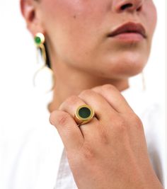 An update of an iconic style, our gold-plated Petra Circle Signet Ring surprises and delights with a beautiful green agate semi-precious stone. Worn alone or with a stack of rings, Petra always stands out. Crafted from a layer of gold over Italian brass, the Petra Circle Signet Ring is shaped and polished by hand. Pair Petra with a matching manicure to really make her pop. Details Everything you need to know. Measures 1.5 cm on it's face. Sizes 5-9 Handcrafted from semi-precious stones and gold Modern Yellow Gold Jade Jewelry, Modern Gold Emerald Ring For Everyday, Modern Gold Rings With Emerald, Polished Chrysoprase Ring Jewelry, Yellow Gold Green Onyx Gemstone Jewelry, Yellow Gold Agate Ring, Green Gold-plated Everyday Jewelry, Modern Gold Emerald Ring, Everyday Green Gold Plated Jewelry