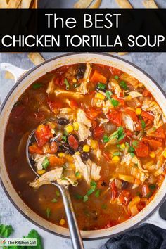 A pot of chicken tortilla soup with shredded chicken, black beans, corn, tomatoes, and cilantro. A spoon is in the pot, and a banner at the top reads, The BEST CHICKEN TORTILLA SOUP. The bottom corner has The Kitchen Girl logo.