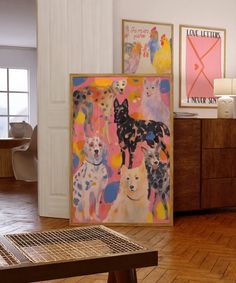 there are many paintings on the wall in this room, including one of them is dogs