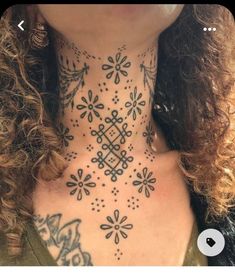 a woman with tattoos on her neck and chest