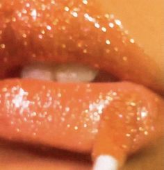 a close up view of a person's lips with glitter on them