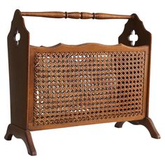 an old fashioned wooden basket with handles on it's legs, and some holes in the side