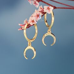 These cute dainty crescent moon hoop earrings are made of solid 925 sterling silver and 18k gold plate, features cute dangle drop crescent moon on hoop closures.Hoop earrings ear huggies are comfortable to wear all the time.Add these crescent moon hoop earrings to your everyday fine jewelry collection or as gift for your love one. Jewelry Care: See more information about how to care for your jewelry here. Shipping Policy: Orders will be shipped within 1-3 business days. Economy shipping will tak Yellow Gold Sterling Silver Earrings With Moon Charm, Gold Crescent Hoop Earrings With Moon Phase, Sterling Silver Crescent Cartilage Earrings With Moon Charm, Gold Sterling Silver Earrings With Moon Charm, Dainty Half Moon Charm Earrings, Dainty Half Moon Earrings With Moon Charm, Elegant Half Moon Gold Hoop Earrings, Elegant Gold Half Moon Hoop Earrings, Yellow Gold Moon Charm Drop Earrings