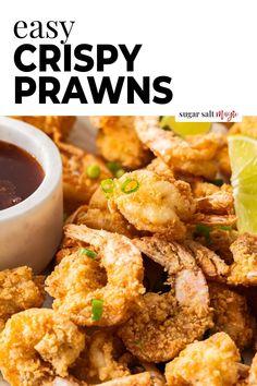 crispy praws on a white plate with dipping sauce and lime wedges