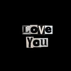 the word love you written in cut out letters on a black background with space for text