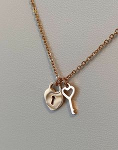 🔐♥️ Unlock Your Heart 💟 A pair of matching necklace for you and your love one! The necklace combines a miniature heart lock and key on a classic rose gold cable chain. Versatile and lightweight, easy to carry and looks fabulous with your everyday wear! The chain is 16 inch length with 5cm extension chain. Charm size: 🔓Lock: 1.7 cm width x 1.4 cm height 🔑Key: 1.3 cm width x 1.6 cm height ♥️ A silver tone heart lock and key style is also available at this direct link: www.etsy.com/ca/listing/1 Rose Gold Charm Necklaces For Anniversary Gift, Rose Gold Necklaces With Charms For Anniversary, Rose Gold Charms Necklace For Anniversary Gift, Rose Gold Charm Necklaces For Valentine's Day Anniversary, Rose Gold Charm Necklace For Valentine's Day Anniversary, Double Heart Rose Gold Necklace With Charms, Rose Gold Charm Necklaces For Anniversary On Valentine's Day, Gold Initials Charm Necklace For Valentine's Day, Valentine's Day Rose Gold Necklaces With Charms