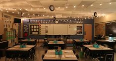 an empty classroom with desks and lights on the ceiling is pictured in this image