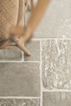 a close up of a chair on a tiled floor