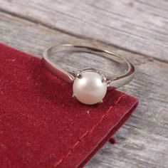 "This Sterling Silver Ring features an Elegant Art With Natural Pearl Gemstone. The cavity is made from genuine solid 925 sterling silver and stamped as S925. This Jewelry is Lead free and Rhodium plated to resist scratches and tarnish. ITEM DESCRIPTION Item Code: JARG160 Metal: 925/92.5 Sterling Silver Gemstone: Genuine Natural Cultured Pearl Gemstone Shape: Round Gemstone Size: 7 MM Round Ring Length: 7 MM Ring width: 7 MM Weight: 2.17 gm approx **Keep the jewelry away from direct heat, water, Silver Pearl Ring For Women, Sterling Silver Rings With Classic Design, Classic Design Silver Rings In Sterling Silver, Classic Sterling Silver Rings In Silver, Sterling Silver Pearl Ring With Polished Finish, Sterling Silver Open Pearl Ring With Polished Finish, Classic Sterling Silver Birthstone Ring With Gemstone, Timeless Pearl Ring In White Gold Sterling Silver, Timeless Silver Round Pearl Ring