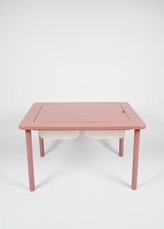 a pink table with two white bowls on it's legs, against a white background