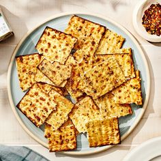 crackers on a plate with seasoning next to them