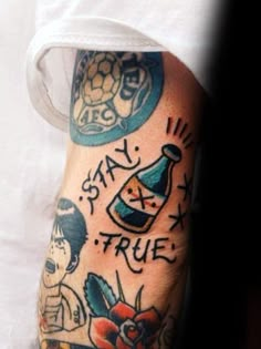 a man with tattoos on his arm and leg, showing the words stay true in different languages