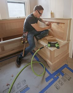 a man is working on some wood in his house