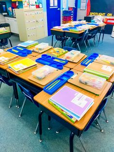 an empty classroom with desks and books on them