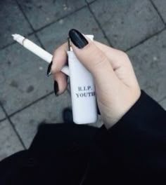 a woman holding a white lighter in her right hand with the words help yourself written on it