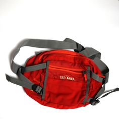 Elevate your adventure gear with the vibrant TATONKA Red Waist Bag, the ultimate companion for on-the-go storage. Crafted for convenience, this stylish waist bag boasts multiple compartments secured with robust zippers, ensuring your essentials are organized and accessible. The adjustable strap features a sturdy buckle, providing a customizable fit that promises comfort and security around your waist. Whether you're hiking rugged trails, traveling through cities, or dancing at festivals, this wa Cheap Red Baguette Bag For Travel, Functional Shoulder Bag With Zipper For Hiking, Multifunctional Red Bags For Outdoor Activities, Red Travel Pouch Belt Bag, Red Pouch Belt Bag For Travel, Casual Red Shoulder Bag For Outdoor Activities, Multifunctional Red Bag With Zipper Closure, Functional Bags For Outdoor Activities With Durable Zipper, Red Bags With Pockets For Outdoor Activities