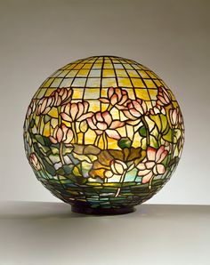 a stained glass vase sitting on top of a table