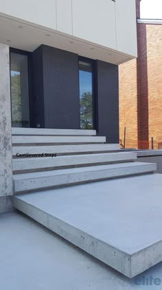 concrete steps leading up to the front door of a building