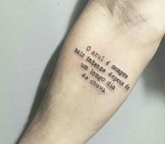 a person's arm with a quote tattooed on the left side of their arm