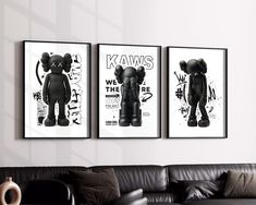 three black and white posters hang on the wall above a couch in a living room