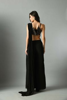 Moonshine, our pre-draped saree in black and it is elegant and fuss-free and A stunning Nylah bustier to make your outfit look unique. Add a touch of style to your wardrobe with the Moonshine pre-draped saree with nylah bustier set. Crafted in crepe silk, it is adorned with zari Embroidery. The black color will add a subtle and elegant touch to your look.Composition and care Crepe silk Hand wash or dry clean only GARMENT MEASUREMENTS Size Bust Waist Hip Neck Shoulder Arm Hole XS 32” 26” 35” 13” 14” 13” S 34” 28” 37” 13.5” 14.5” 14” M 36” 30” 39” 14.5” 15” 15” L 38” 32” 41” 15.5” 15.5” 16” XL 40” 34” 43” 16.5” 16 17” Ships Worldwide from India.MADE IN INDIA Black Draped Georgette Saree, Black Georgette Draped Saree, Black Draped Saree With Sheer Dupatta, Glamorous Black Pre-draped Saree, Festive Fitted Pre-draped Saree For Gala, Elegant Black Pre-draped Saree For Evening, Georgette Saree With Draped Sleeves For Evening, Black Bollywood Style Pre-draped Saree, Glamorous Black Fitted Pre-draped Saree