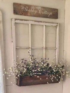 an old window is filled with white flowers