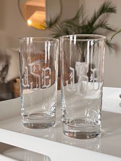 two glasses sitting on top of a counter