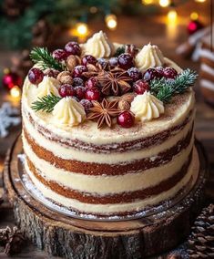 a christmas cake decorated with pine cones, cinnamons and cranberries on a tree stump