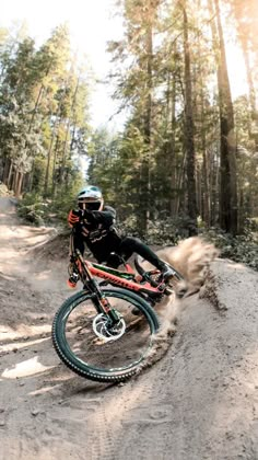 a man riding a dirt bike on top of a forest