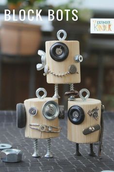 three wooden robot sculptures sitting on top of a table