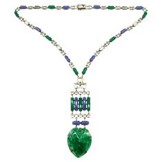 An outstanding Art Deco pendant necklace in highly characteristic colour and design. It is composed of blue and green chalcedony glass rounded baguettes throughout, highlighted with clear cut paste rectangular and square faceted stones. The striking pendant is made of moulded marbled green glass, in a stylised 'heart' design, with moulded patterns to emphasise the decoration. The necklace meets at the back, with a secure push clasp. The necklace is made from silvered metal and is either of Frenc Modern Green Necklace For Formal Occasions, Formal Glass Pendant Necklaces, Formal Glass Pendant Necklace, Glass Pendant Necklace For Formal Occasions, Glass Pendant Necklaces For Formal Events, Art Deco Pendant Necklace, Art Deco Silver, Necklace Art, Green Chalcedony