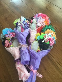 a bunch of colorful hair clips sitting on top of a wooden floor