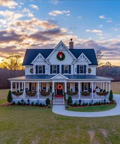 a large white house with wreaths on the front