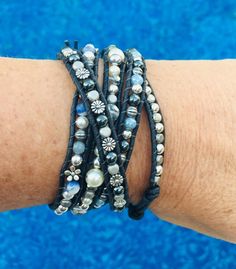 This is our newest 5 wrap bracelet. The wrap is a spiral design, in that each wrap of the wrist looks like a unique bracelet. It measures 33" to 37" using a silver button and 5 loops for the closure. It is bound by natural black leather.This wrap uses 4mm beads (sterling silver, hematite, blue sodalite, Swarovski pearls, pewter, angelite and silver flowers). It will add a serious pop of style to casual denim! It was designed to accent your outfits.The wrap will be delivered in a Wrapped to Wear Festival Hand Wrapped Wrap Bracelet, Adjustable Wrap Bracelet For Festival, Unique Adjustable Wrap Bracelet For Festivals, Unique Adjustable Wrap Bracelet With Round Beads, Adjustable Multi-strand Spiritual Wrap Bracelet, Adjustable Hand Wrapped Bracelet For Festivals, Adjustable Hand Wrapped Wrap Bracelet For Festival, Silver Hand-strung Wrap Bracelet For Festivals, Festival Adjustable Hand Wrapped Bracelet