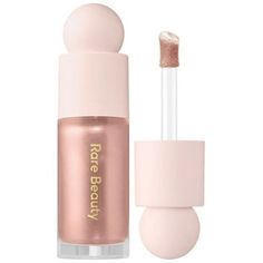 A silky, second-skin Positive Light Liquid Highlighter that creates a lasting, soft, and luminous finish. Packed with light-reflecting pearl particles and a botanical blend of lotus, gardenia, and white waterlily, this multidimensional formula lends skin a dewy glow in seconds. Mix this weightless liquid highlighter with foundation or layer it across the high points of the face for instant radiance. Size: 0.5 oz.  Color: Gold. Positive Light Liquid Luminizer, Liquid Luminizer, Liquid Highlighter, Makeup Wishlist, Luminizer, Highlighter Makeup, Rare Beauty, Benefit Cosmetics, Makeup Items