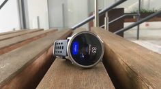 a smart watch sitting on top of a wooden bench