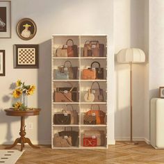 a living room filled with lots of purses and bags on shelves next to a table