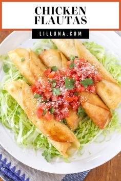 chicken flautass with lettuce and tomatoes on a white plate